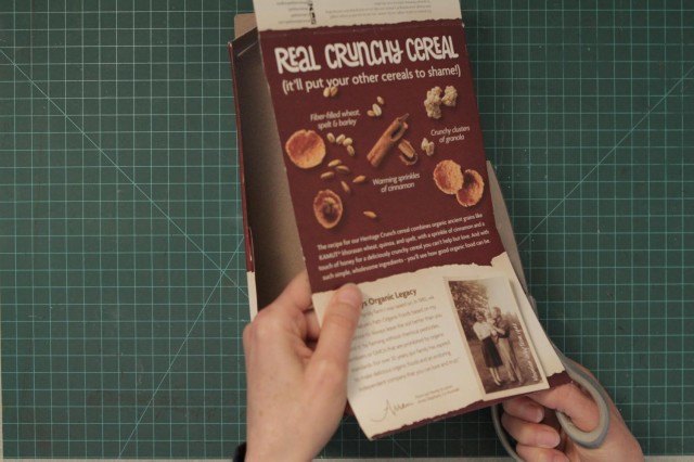 Cereal box being repurposed as cardboard for the journal