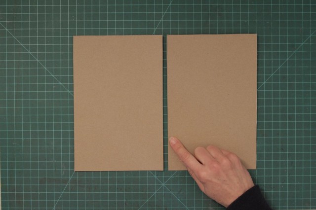 Line up the two cut pieces of cardboard side by side