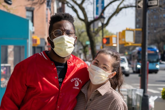 young couple outside wearing face masks