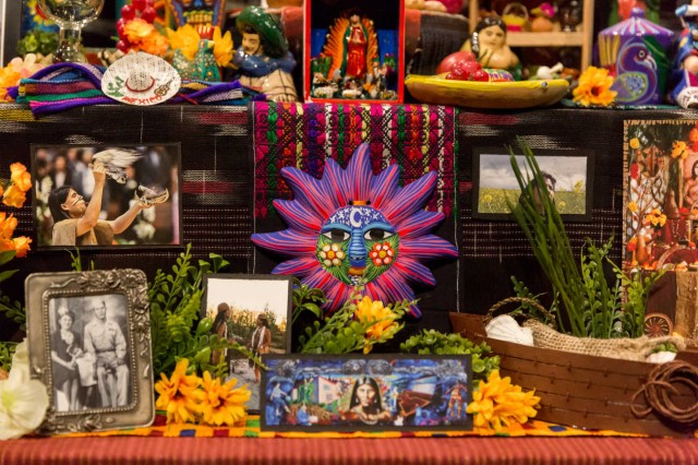 Close up of ceramic sun in ofrenda and toy purina mural 