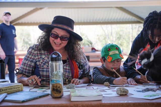 Lila Higgins at a table with children drawing