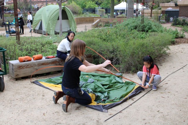 person assembling tent 