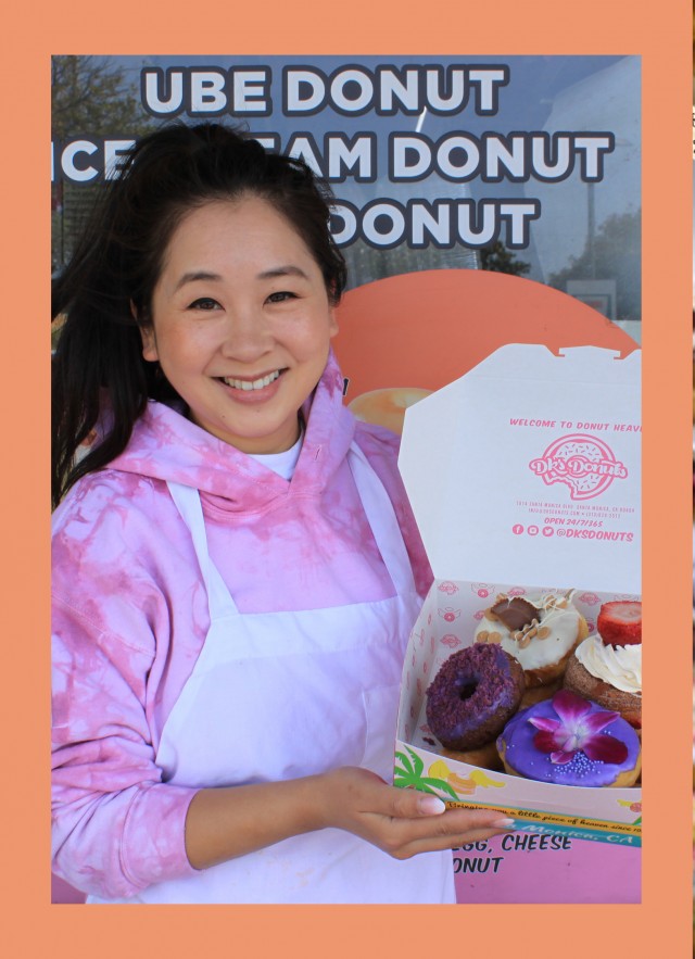 woman holding donuts and donuts in case 
