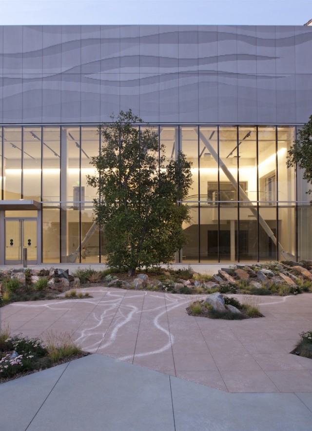 NHM Commons exterior featuring trees and stylized concrete 