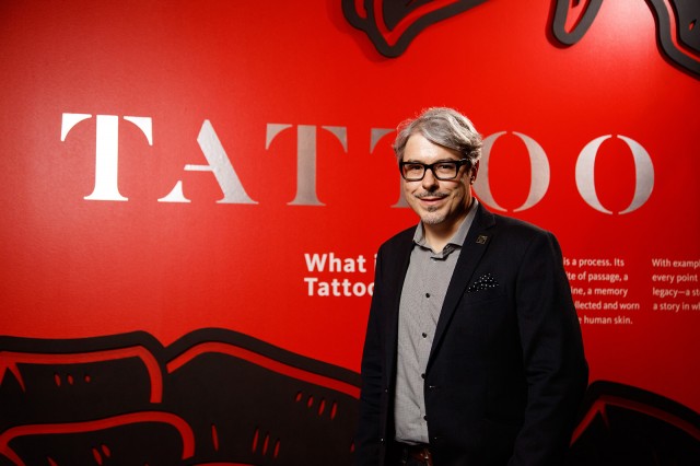 Photo of Lars Krutak at the Tattoo exhibit at NHM