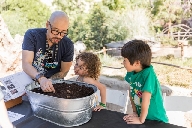 Volunteer with children in Nature Gardens