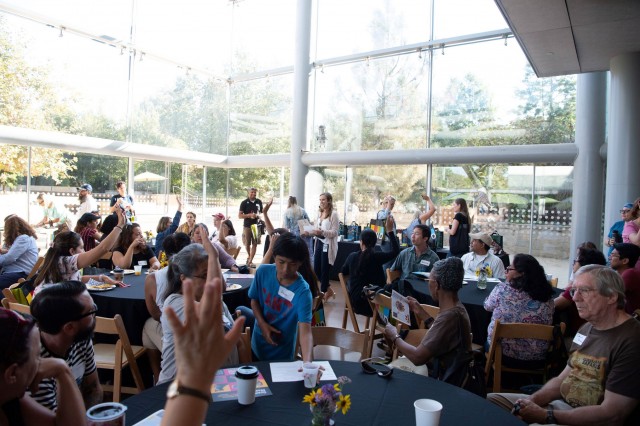 large group of teachers at educator open house participate in annual raffle