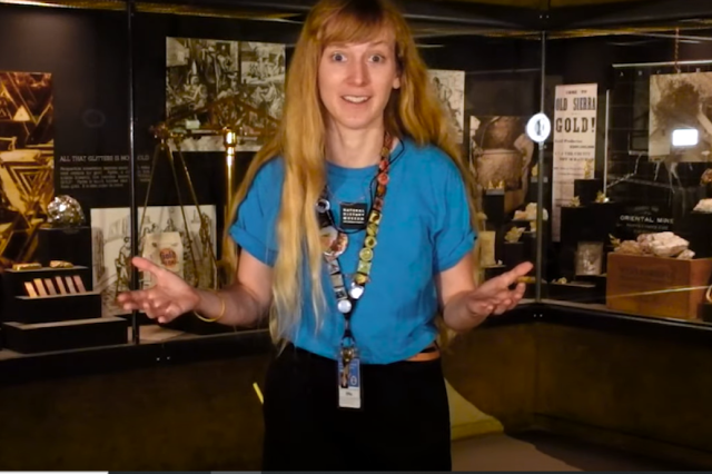 A Museum Educator gestures in front of gold rush objects