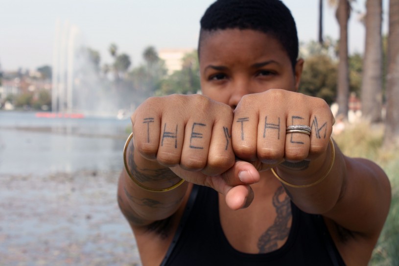 Madin Lopez with hands extended showing &quot;they&quot; and &quot;them&quot; pronouns