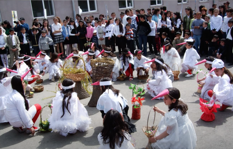 Children dressed in white stork costumes