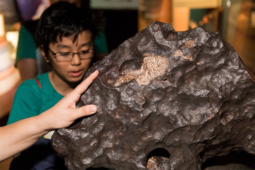 Person touching the Canyon Diablo Meteorite 