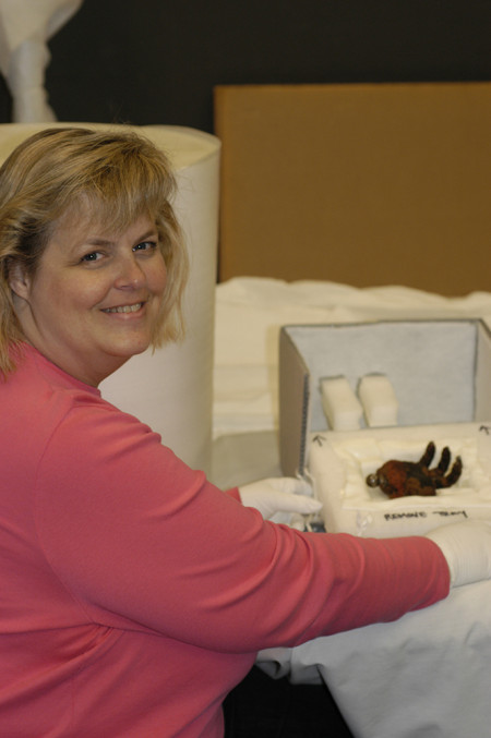Beth Werling wearing gloves by a King Kong hand